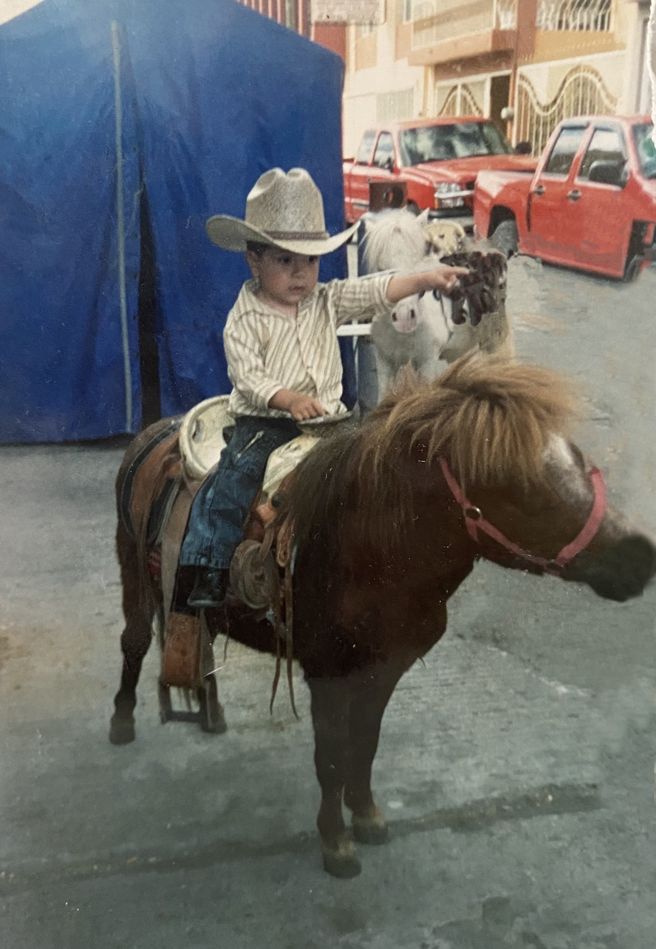 Cowboy baby Jonathan riding a horse